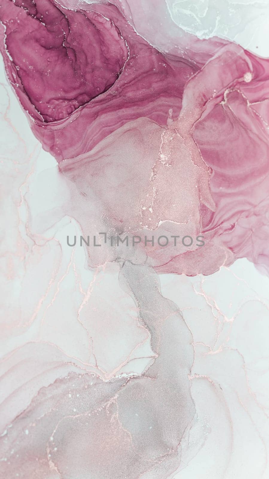 Swirling patterns of alcohol ink create an abstract artwork in soft pink and white tones, highlighting the beauty of fluid ink techniques and artistic expression through color and movement.