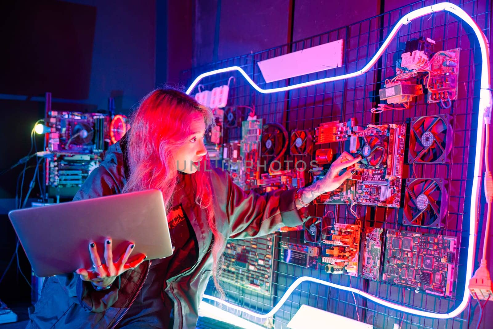 Cyber security. Software engineer holding laptop computer at data center checking hardware, Hacker woman service in server room, check circuit board with many small components