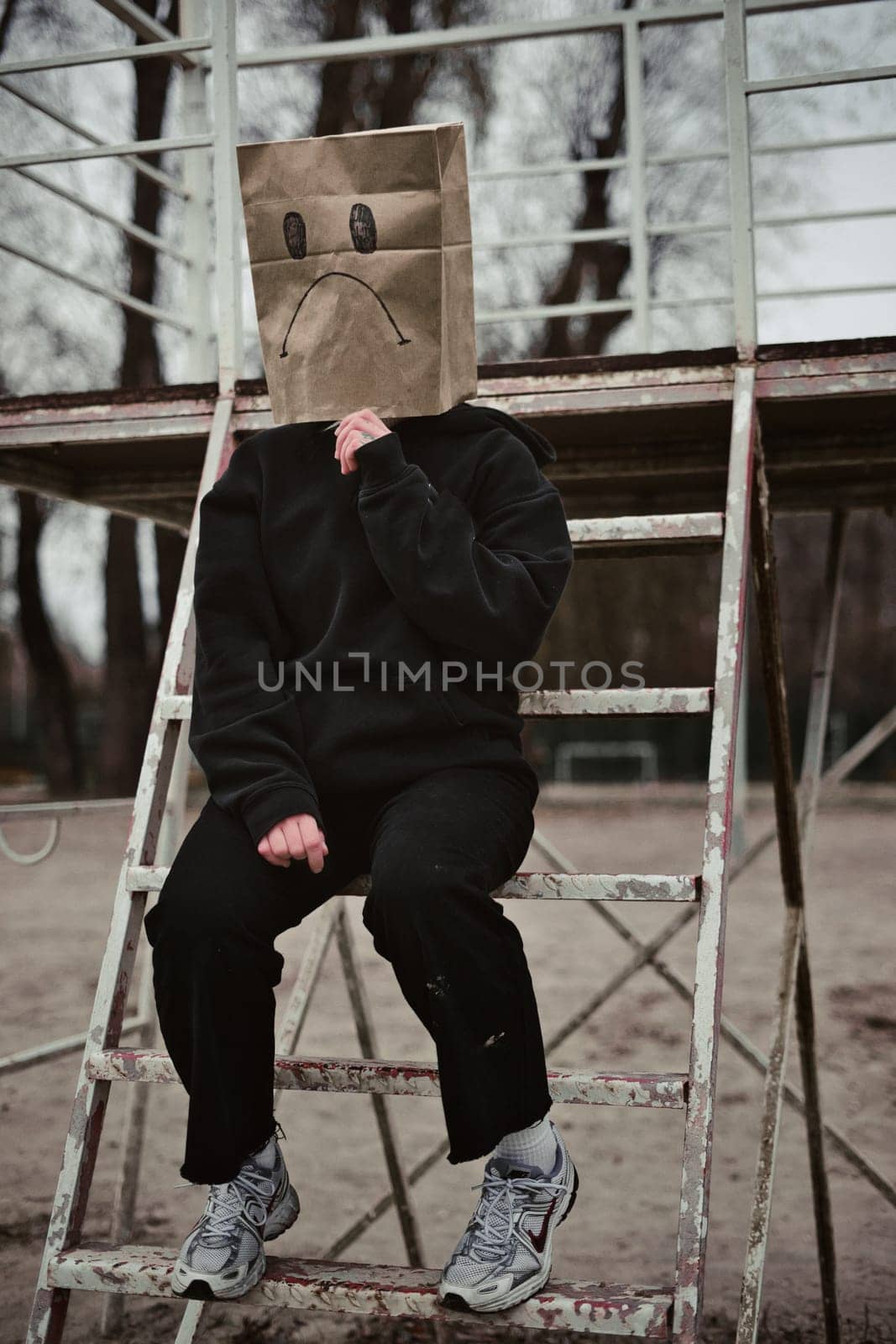Photograph of a teen with a carton head mask . High quality photo