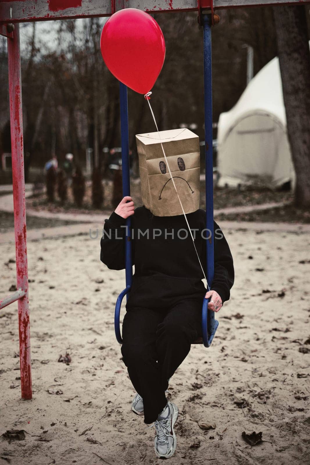 Photograph of a teen with a carton head mask . High quality photo