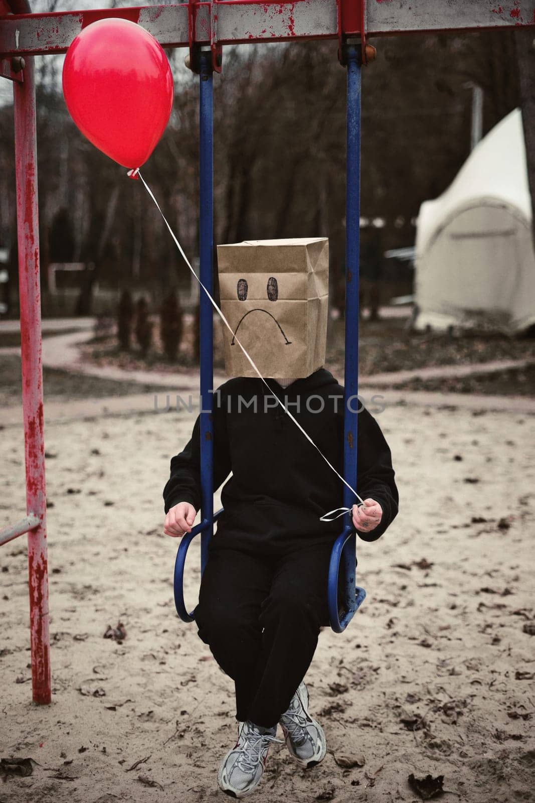 Photograph of a teen with a carton head mask . High quality photo