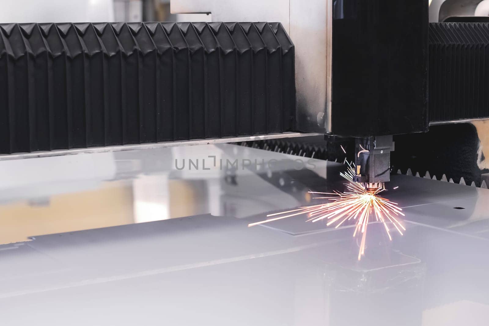 Old Automated CNC laser machine cuts stainless steel sheet. Laser cutting of metal.