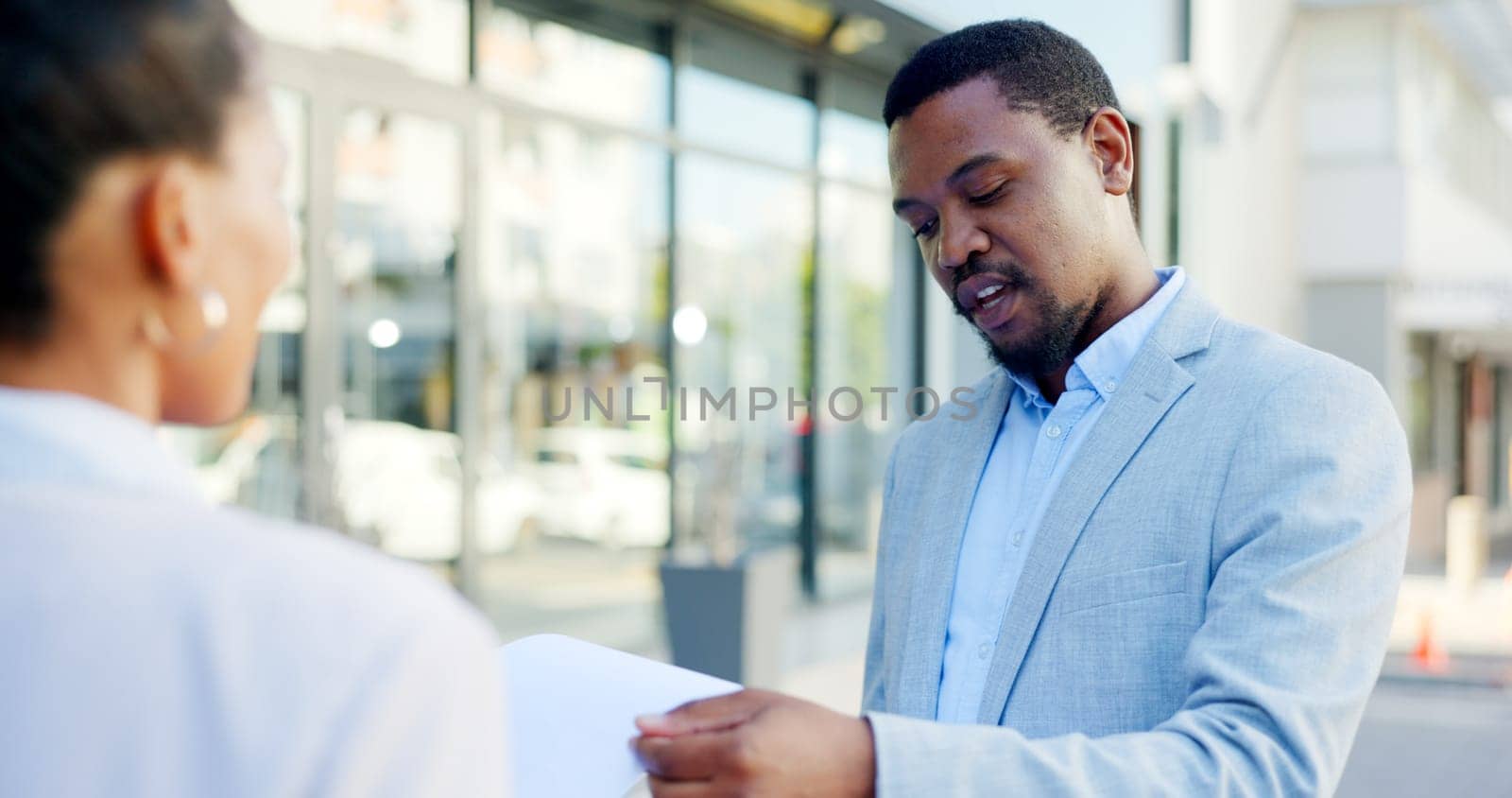 Service, offer and a businessman or salesman talking to a client about a deal in a city or town. Advice, communication and male agent having a conversation in the street with a customer for retail.