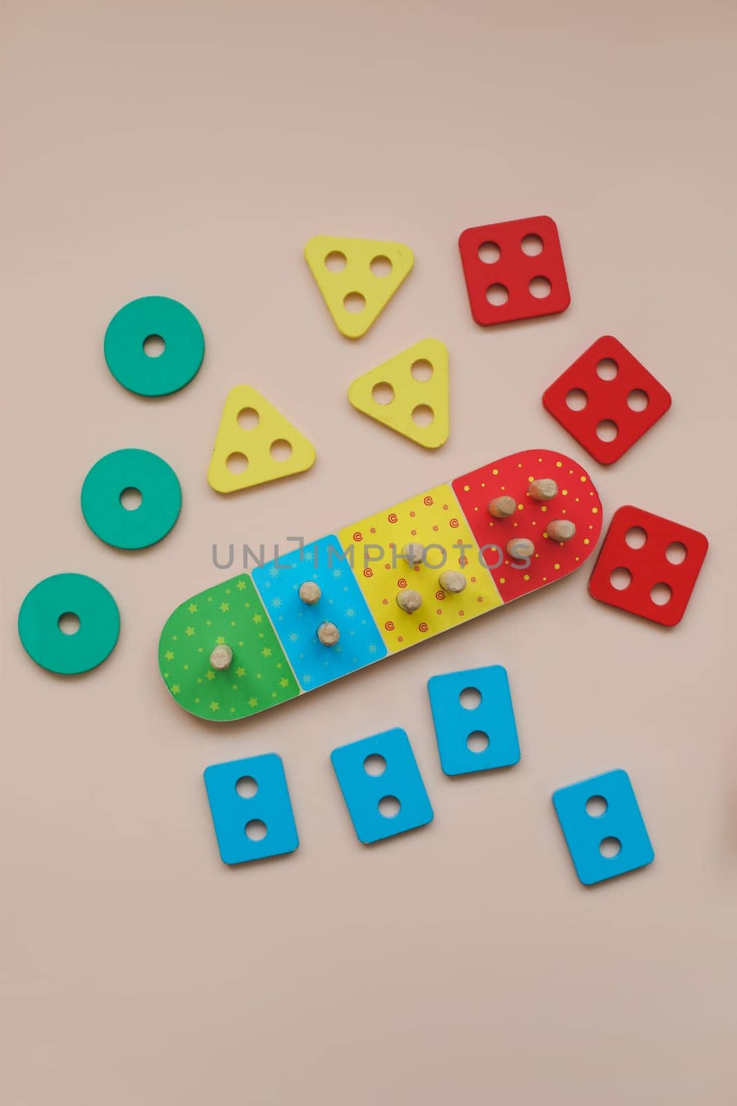 Sorter on neutral background. Multicolored logic sorter close up. Wooden educational logic toy for kid's. Montessori games for early child development.