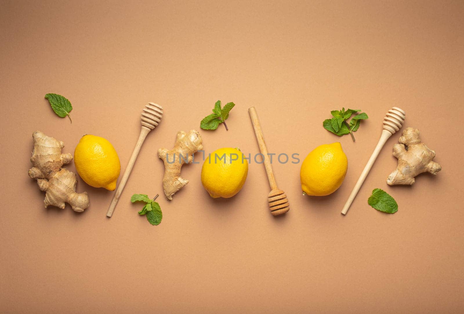 Composition with lemons, mint, ginger top view on simple beige background. Food for immunity stimulation and against seasonal flu. Healthy natural remedies to boost immune system.