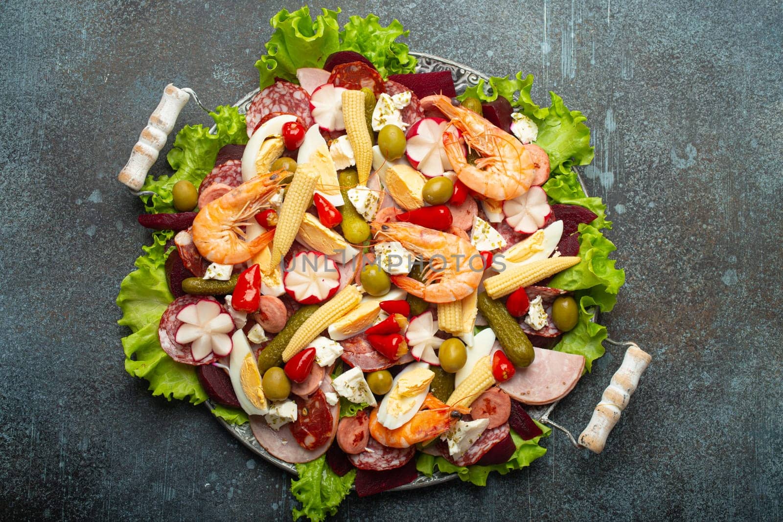 Fiambre, salad of Guatemala, Mexico and Latin America, on large plate top view white wooden background top view with cold cuts, shrimps. Festive dish for All Saints Day (Day Of The Dead) celebration by its_al_dente