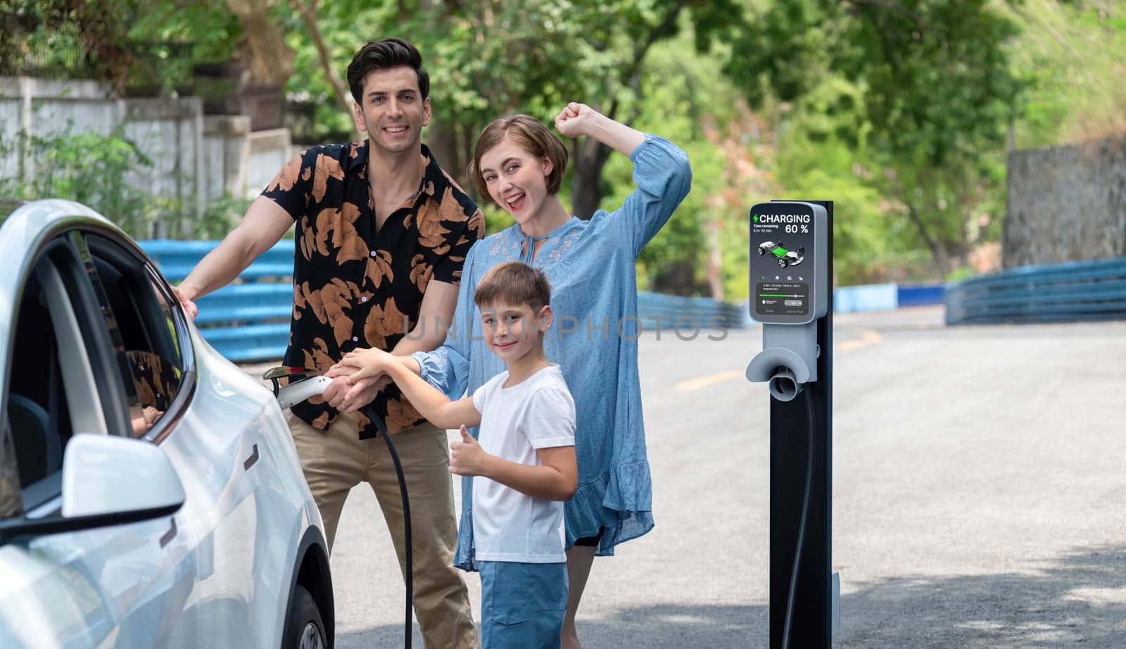 Family road trip vacation with electric vehicle, lovely family recharge EV car with green and clean energy. Natural and eco friendly car travel for sustainable environment. Perpetual