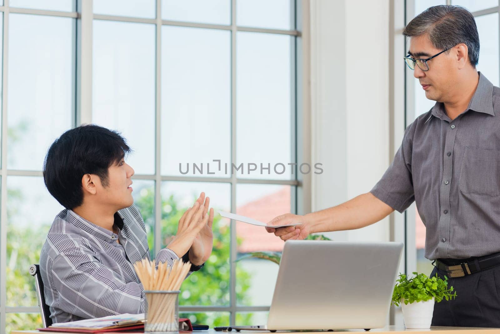 Asian businessman anti bribery and corruption he rejecting money in white envelope offered by partner. Business man sending resignation letter to employee the business downturn to laid off at office