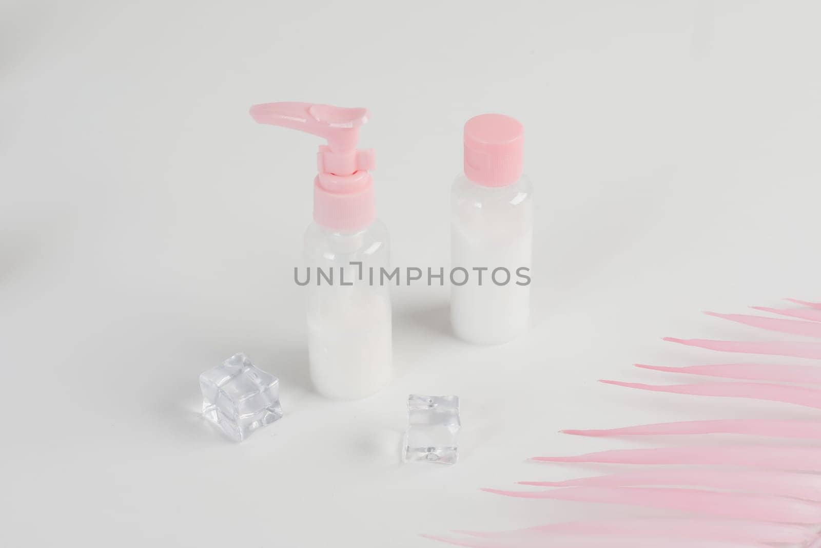 Beauty cosmetics glassbottle. branding mock up, front view on pastel pink and white background. Package for essential oil.