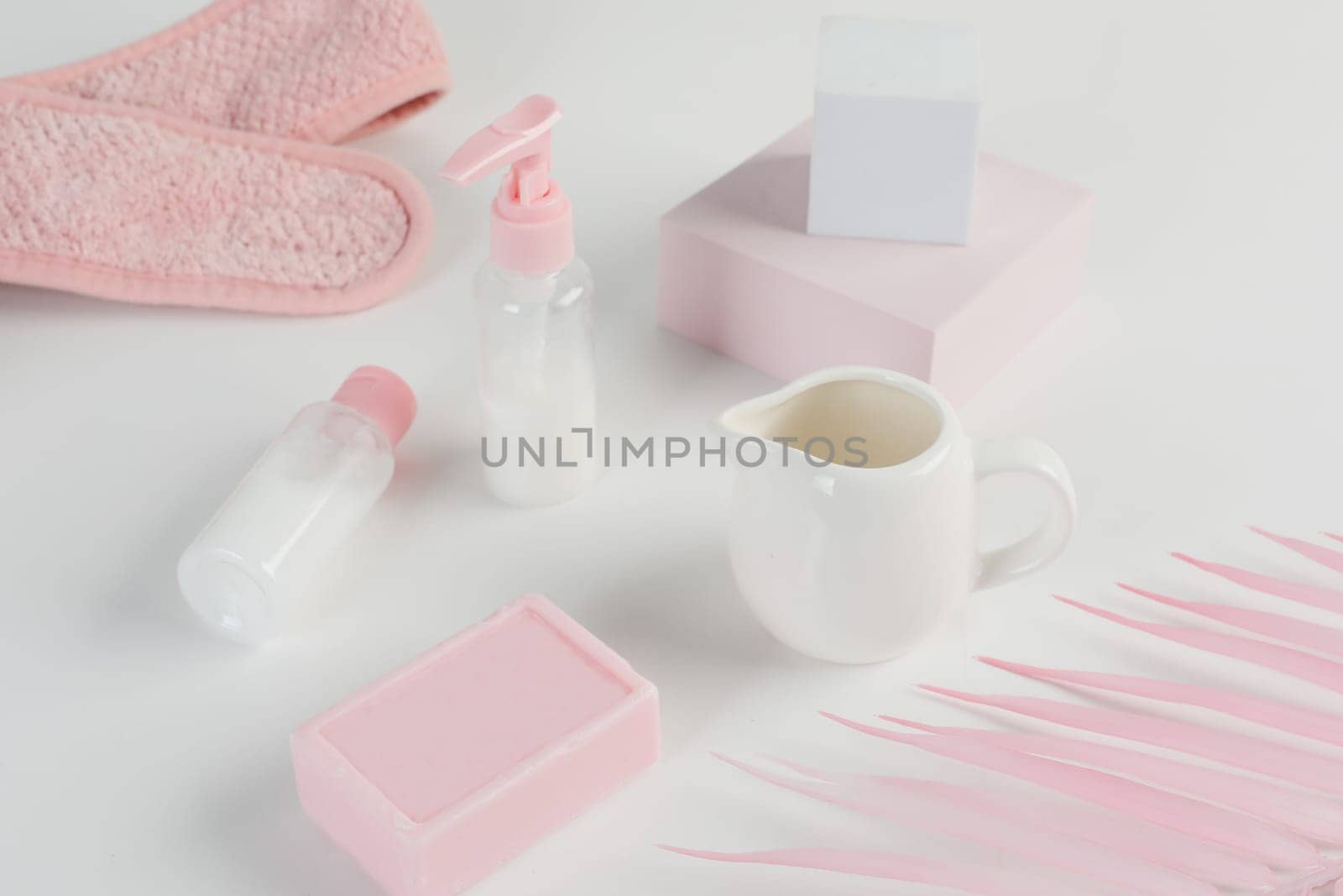 Skincare routine. Pink Women skincare products on white background. Soap, facial foam, cleansing, serum, cream lotion, toothbrush, lipstick. Beauty concept. Natural cosmetic pink flat lay top view.