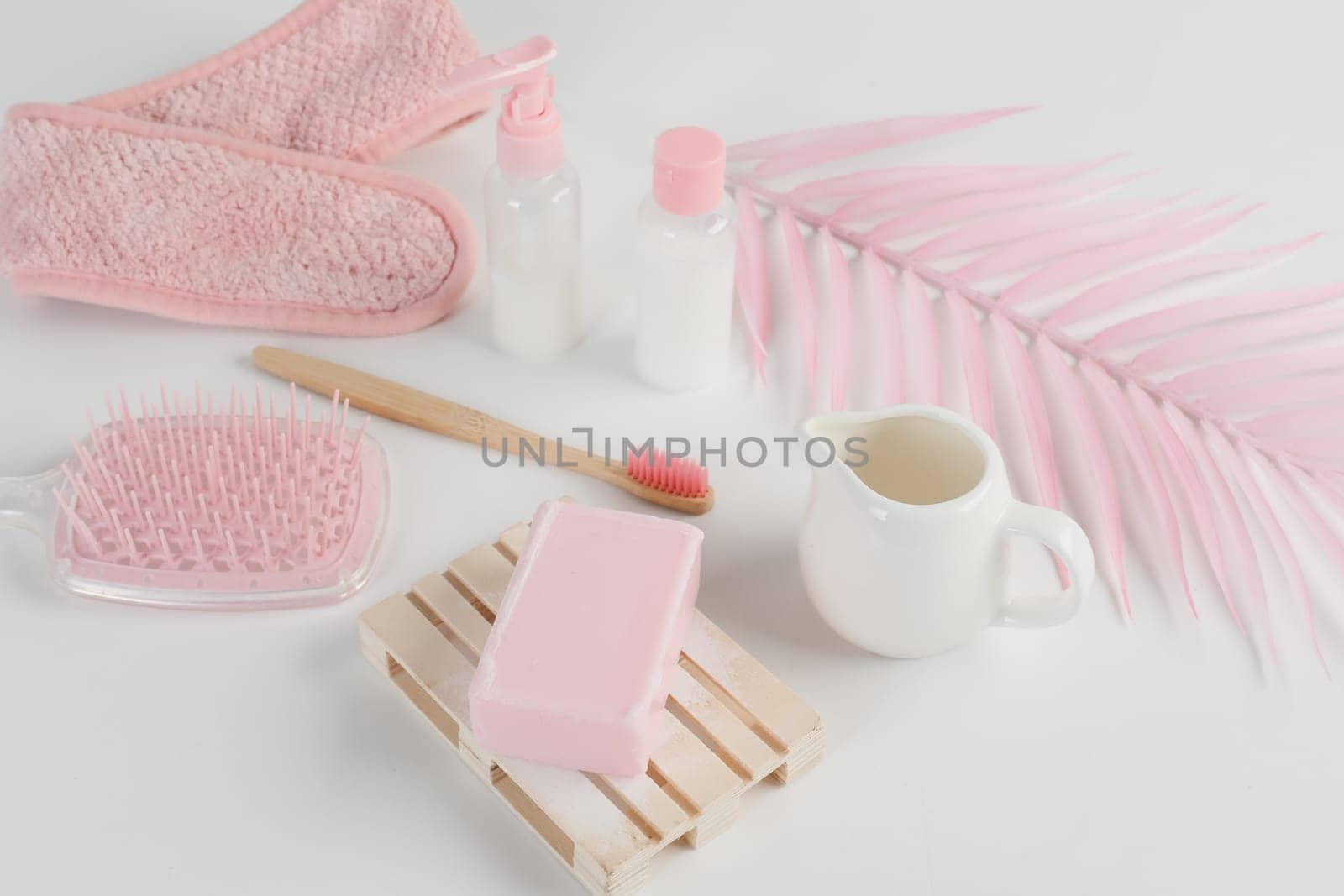 Skincare routine. Pink Women skincare products on white background. Soap, facial foam, cleansing, serum, cream lotion, toothbrush, lipstick. Beauty concept. Natural cosmetic pink flat lay top view.