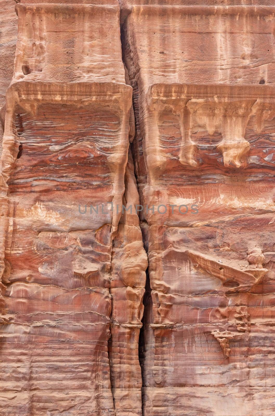 Remains of columns in the rock. Archaeological. site Petra in Jordan. Vertically.