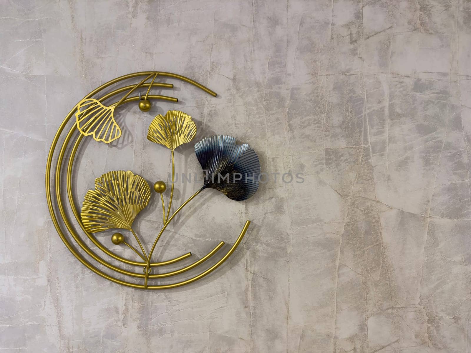 Decorative wall art showcases metallic ginkgo leaves with a blend of gold and blue tones. Perfect for adding a contemporary touch to any living space or office.