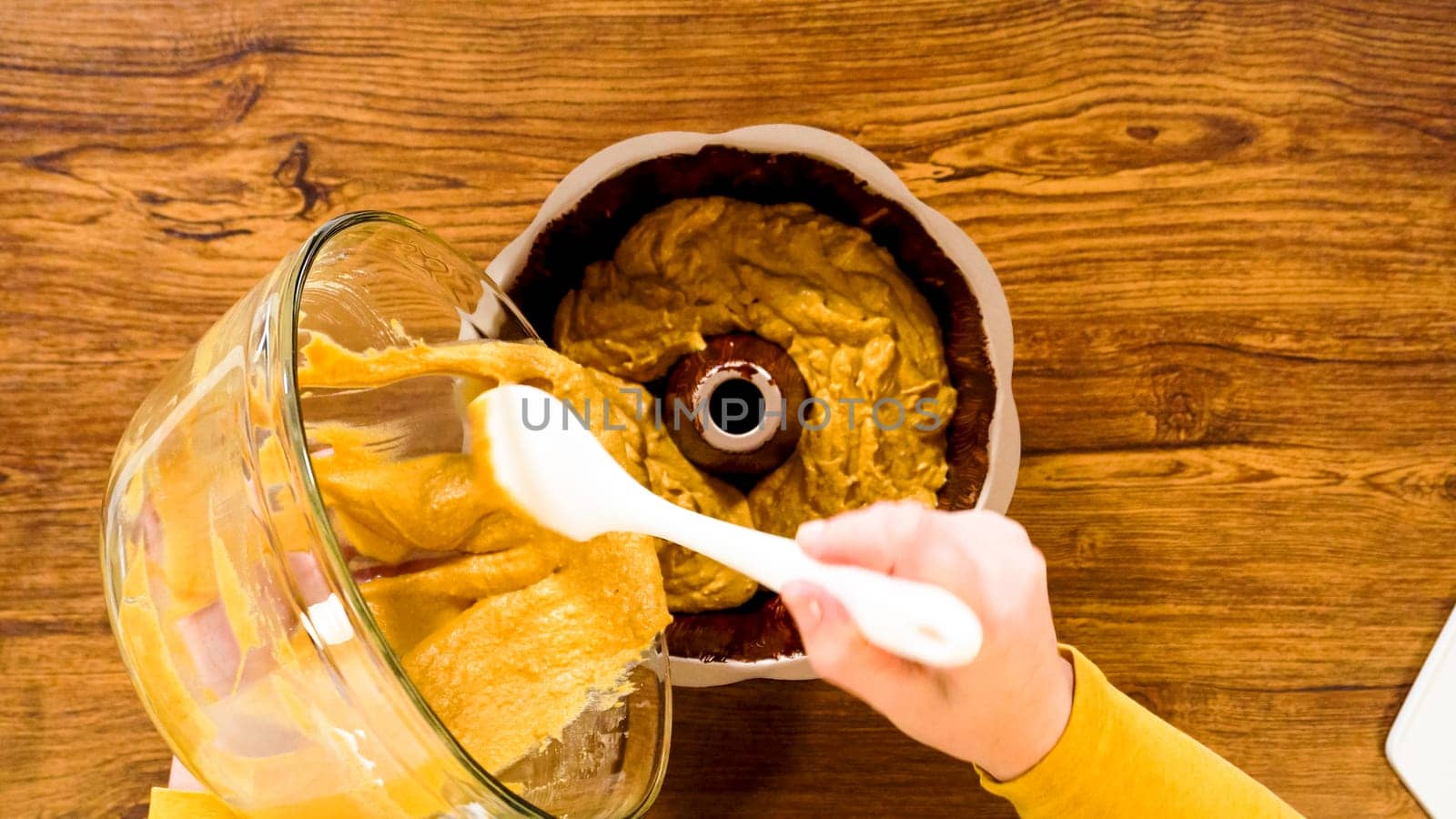 Flat lay. Pouring the gingerbread cake batter into the greased bundt cake pan, ready for a delightful caramel frosting.