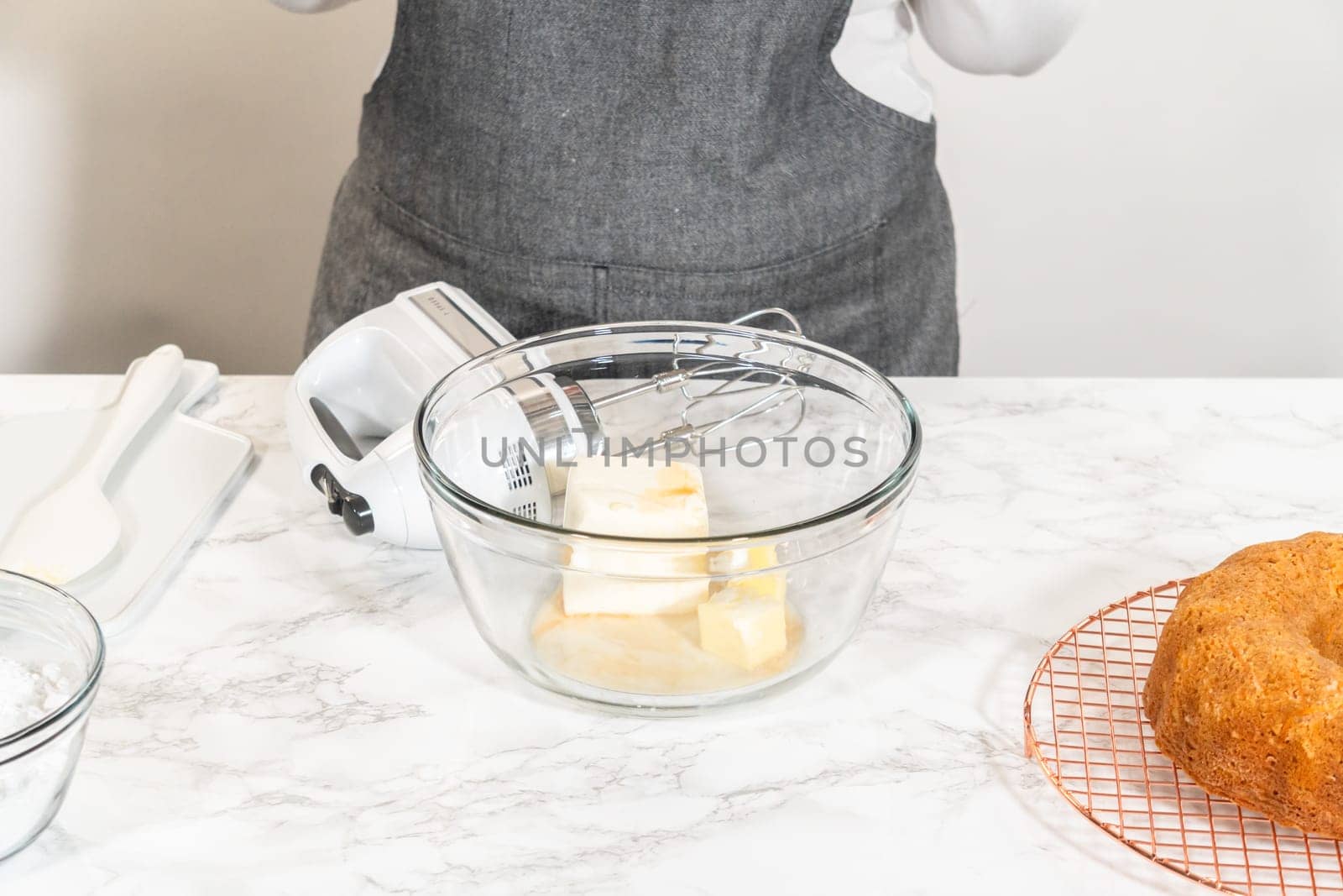 In a large mixing bowl, the ingredients are expertly mixed to create a delectable cream cheese buttercream for the Carrot Bundt Cake.