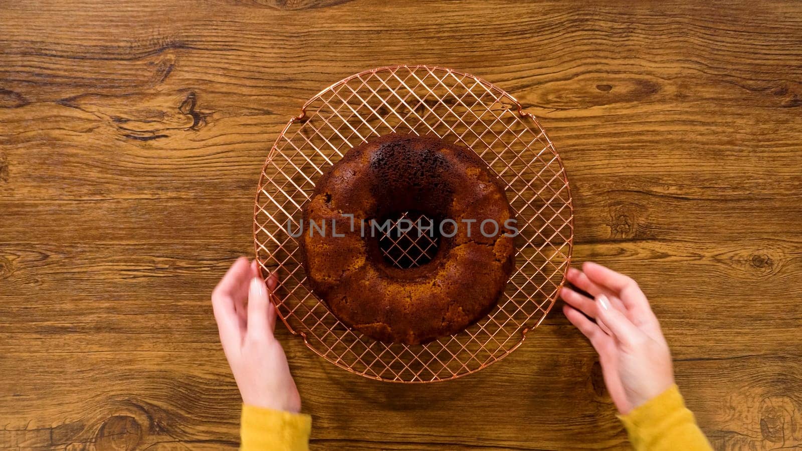 Flat lay. The gingerbread bundt cake gently eases out of its mold onto a wire rack, poised for a drizzle of sweet caramel frosting.