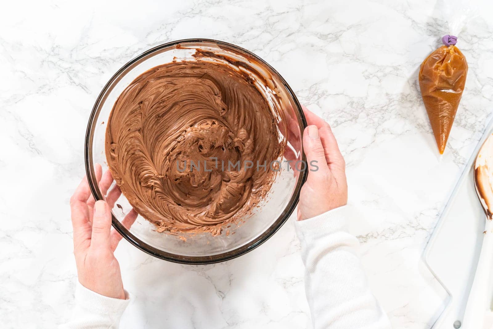 Flat lay. The frosting is whipped to perfection before being piped onto the delicious chocolate cupcakes.