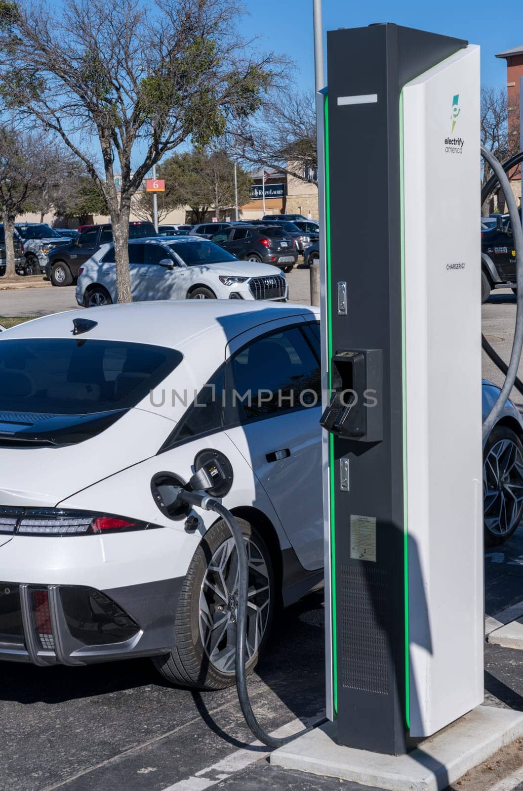Georgetown, TX - 11 January 2025: Hyundai electric car connected to DC high speed charger at Electrify America public charging unit