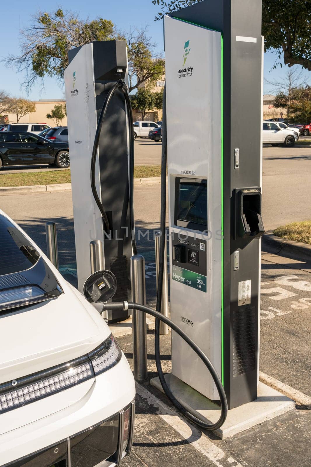 Georgetown, TX - 11 January 2025: Hyundai electric car connected to DC high speed charger at Electrify America public charging unit