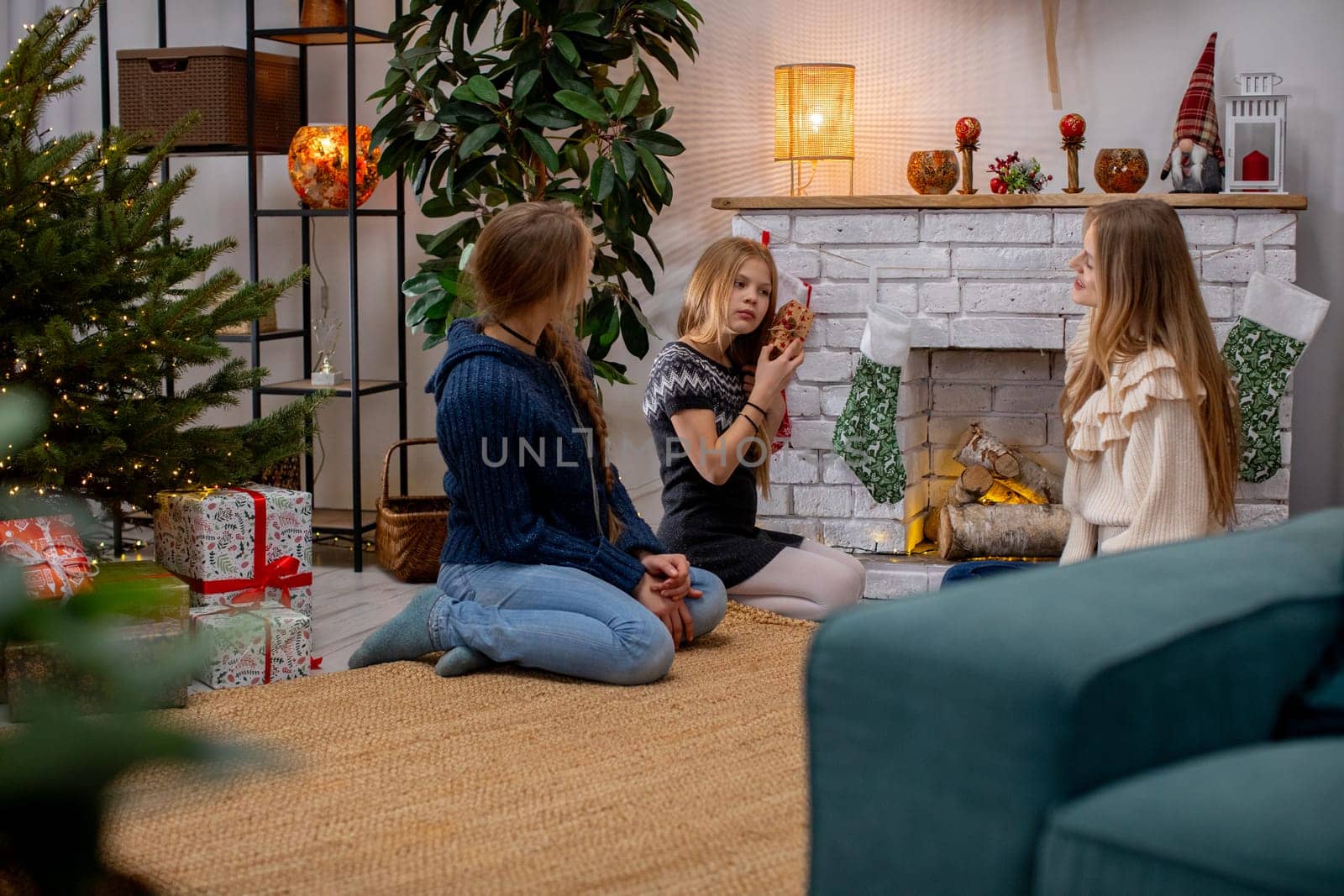 A cozy indoor scene of a family joyfully gathered around a decorated fireplace during the holiday season