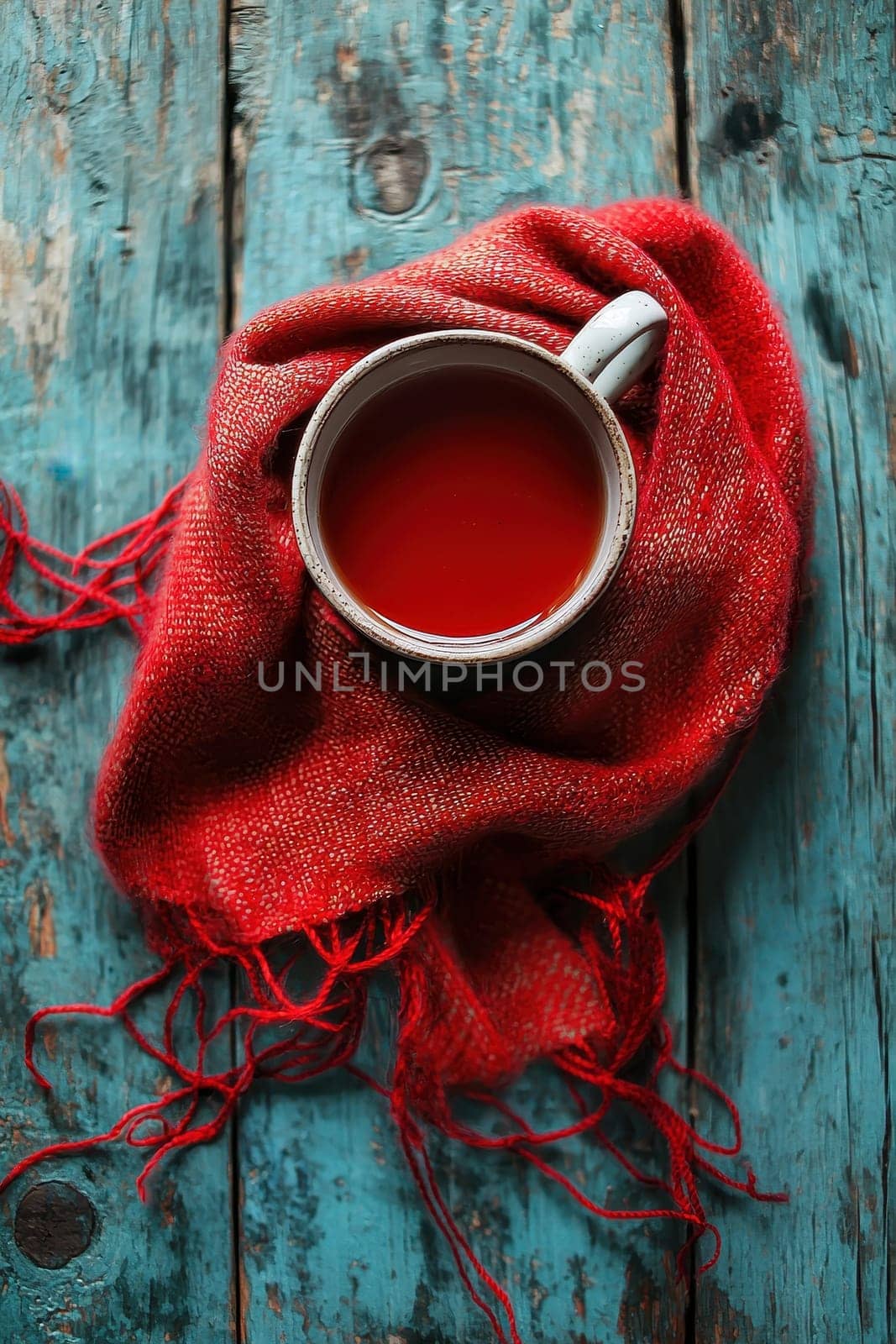 cup of mulled wine and scarf on the table. Selective focus.