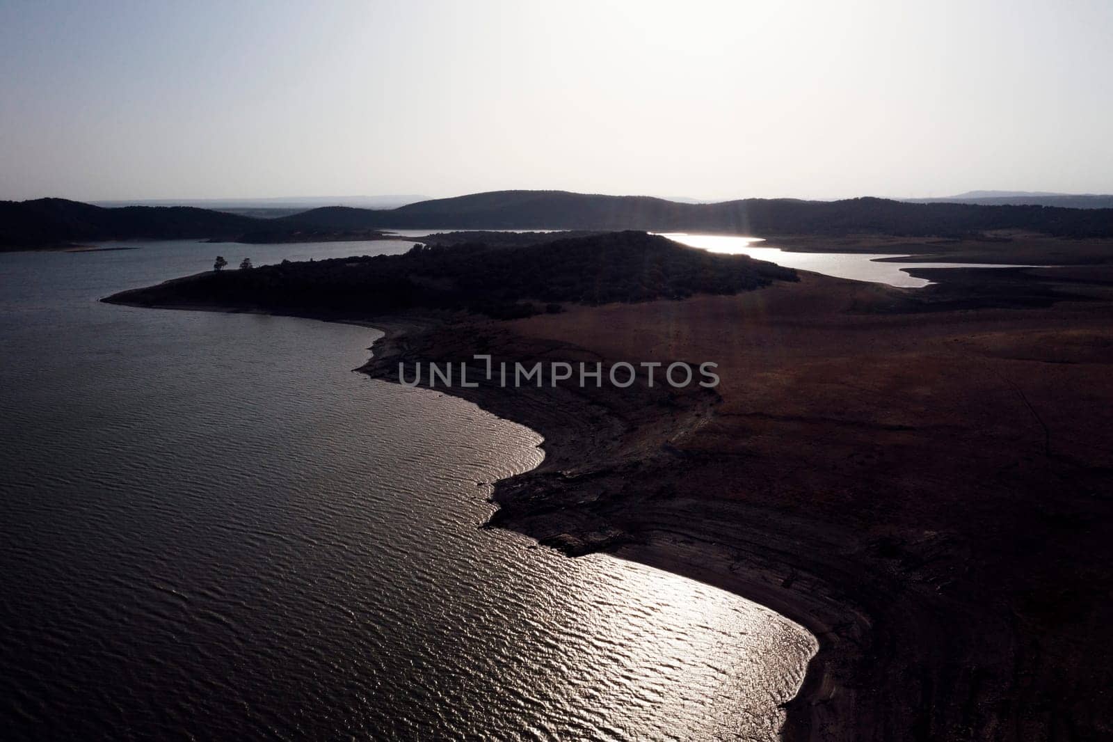 drone view of landscape with hills and lake with calm water, concept of peaceful and serene landscape in the vast expanse of land, copyspace for text