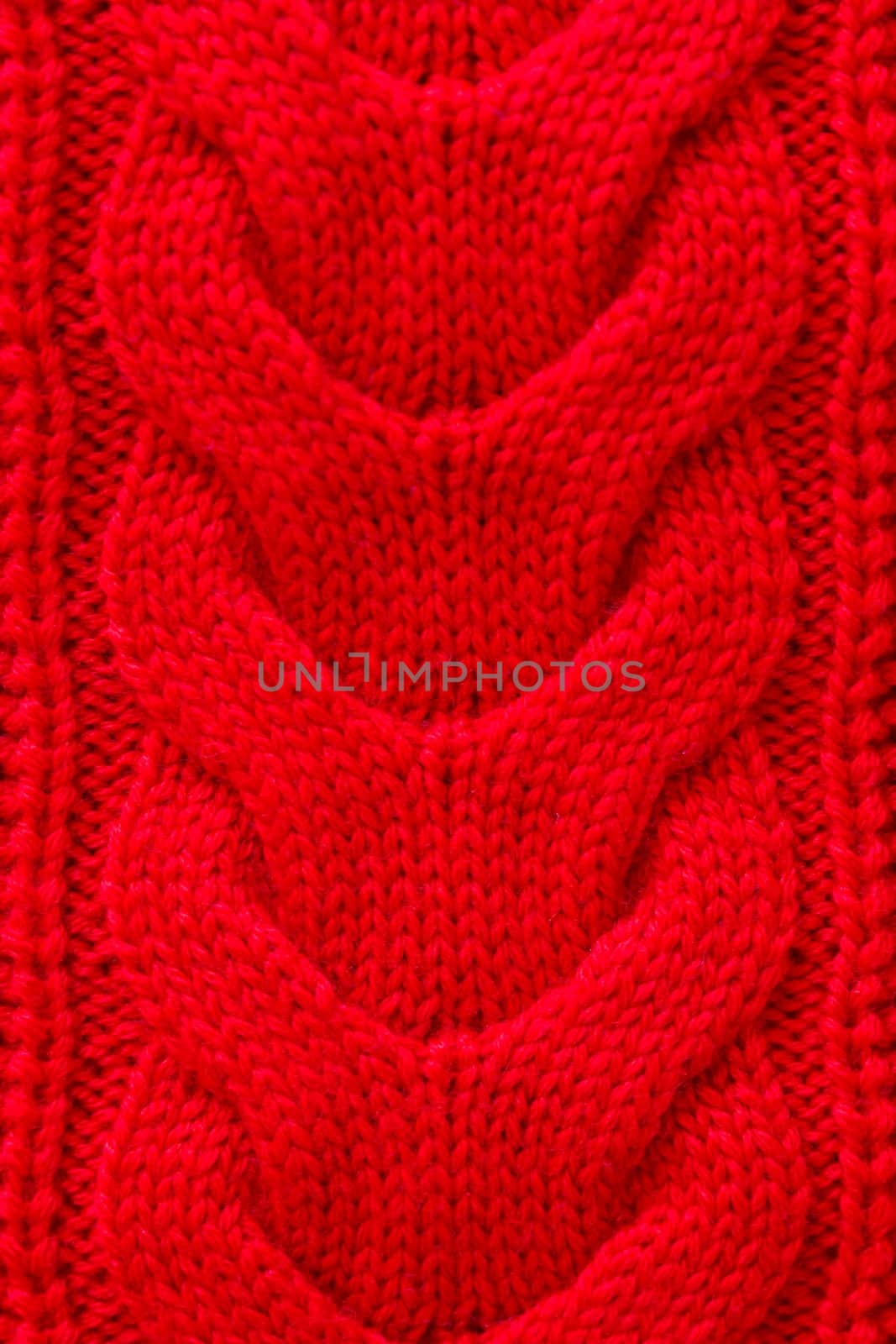 Red knitted winter sweater Background texture