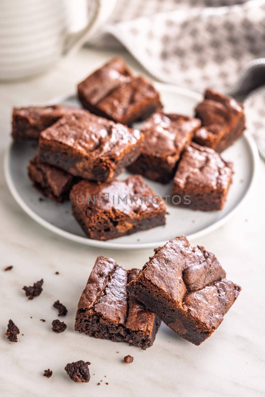 Homemade chocolate brownies on plate on a kitchen table.