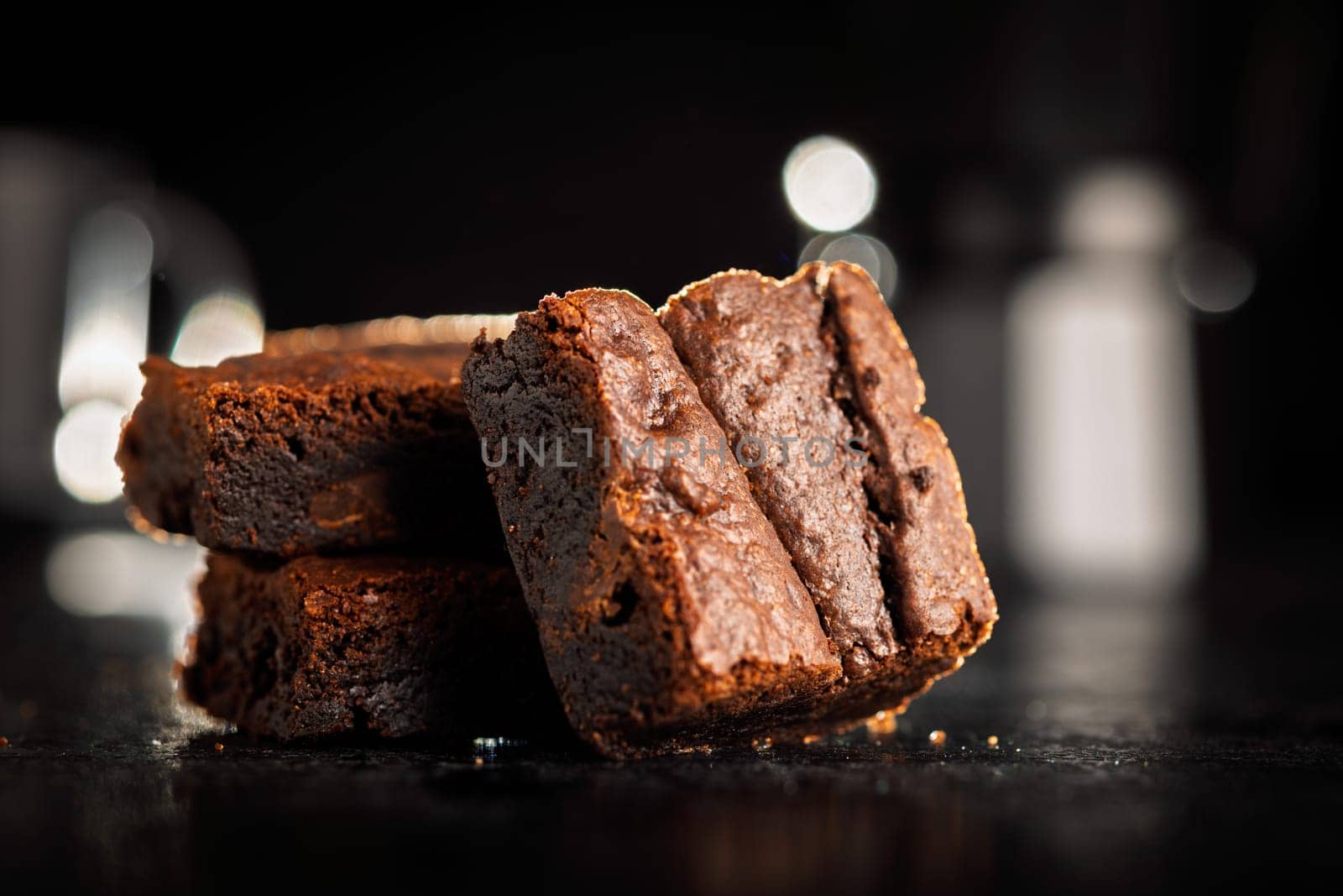 Homemade chocolate brownies on a black table.
