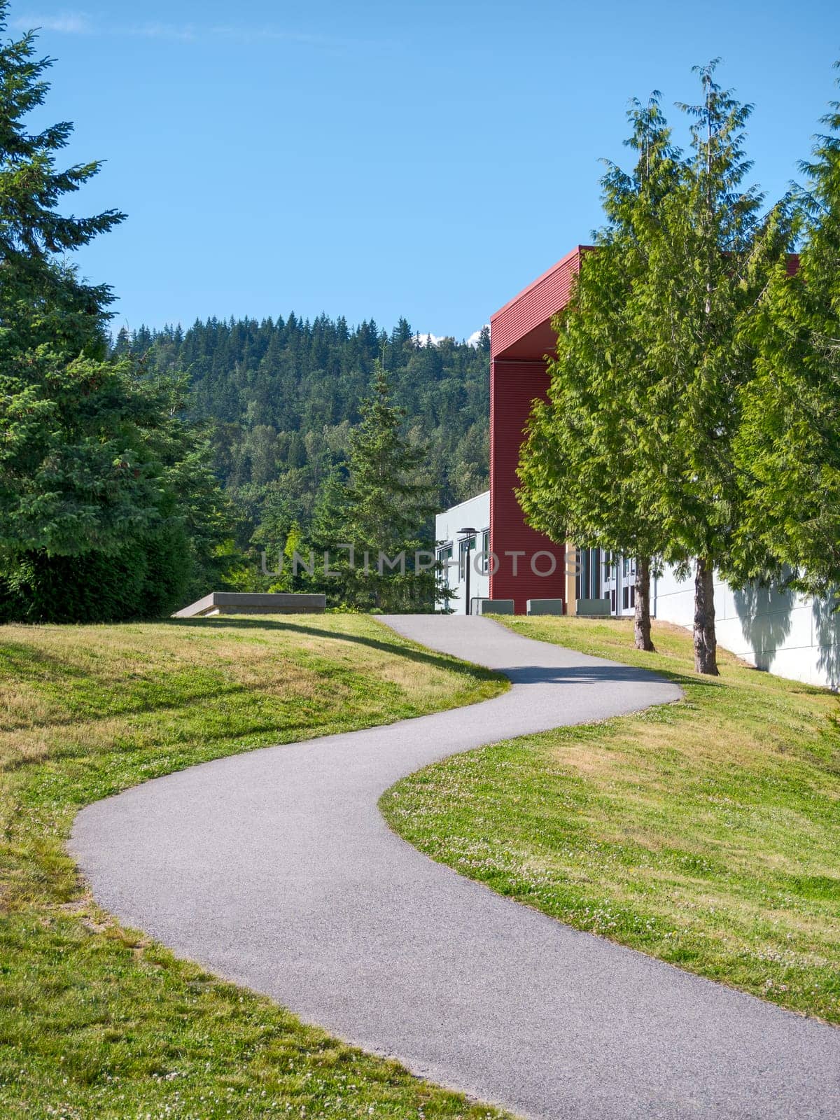 A winding path on the slope leading to an office building.