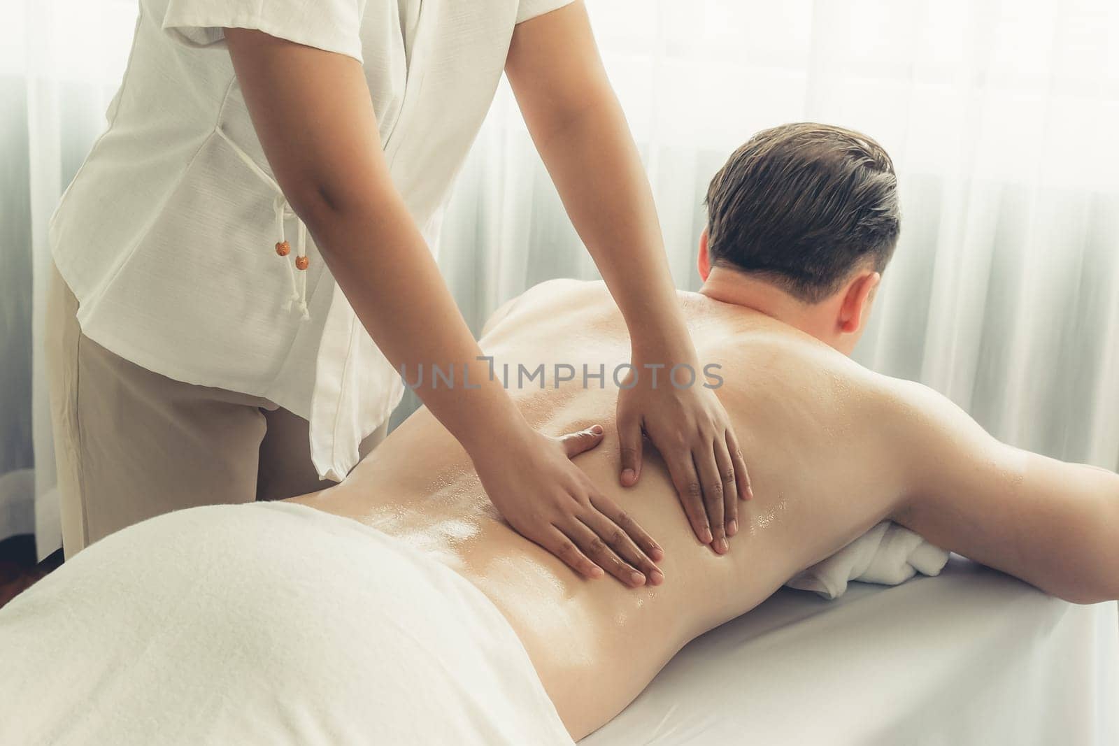 Caucasian man customer enjoying relaxing anti-stress massage. Quiescent by biancoblue