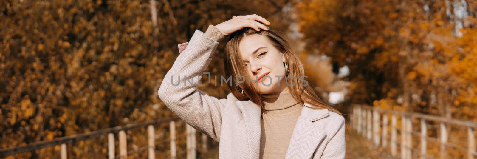 beautiful long-haired woman walks through the autumn streets. Railway, autumn, woman in a coat. by Annu1tochka