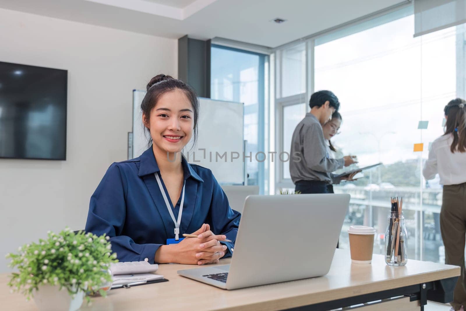 Business people meeting using laptop computer,calculator,notebook,stock market chart paper for analysis Plans to improve quality next month. Conference Discussion Corporate Concept.