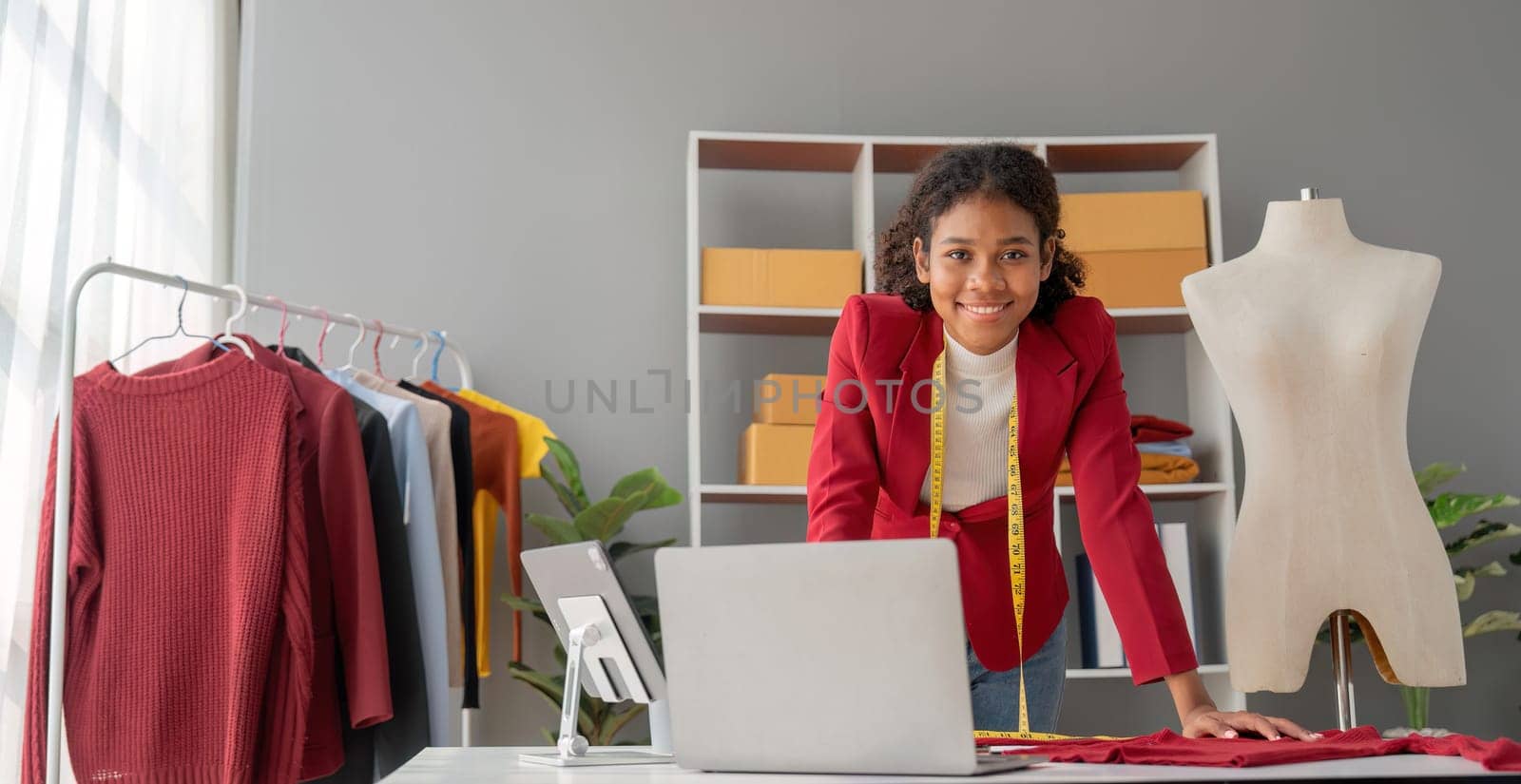 Portrait of young beautiful woman fashion designer stylish stand and working with color samples.Attractive young asian girl working with colorful fabrics at fashion studio.