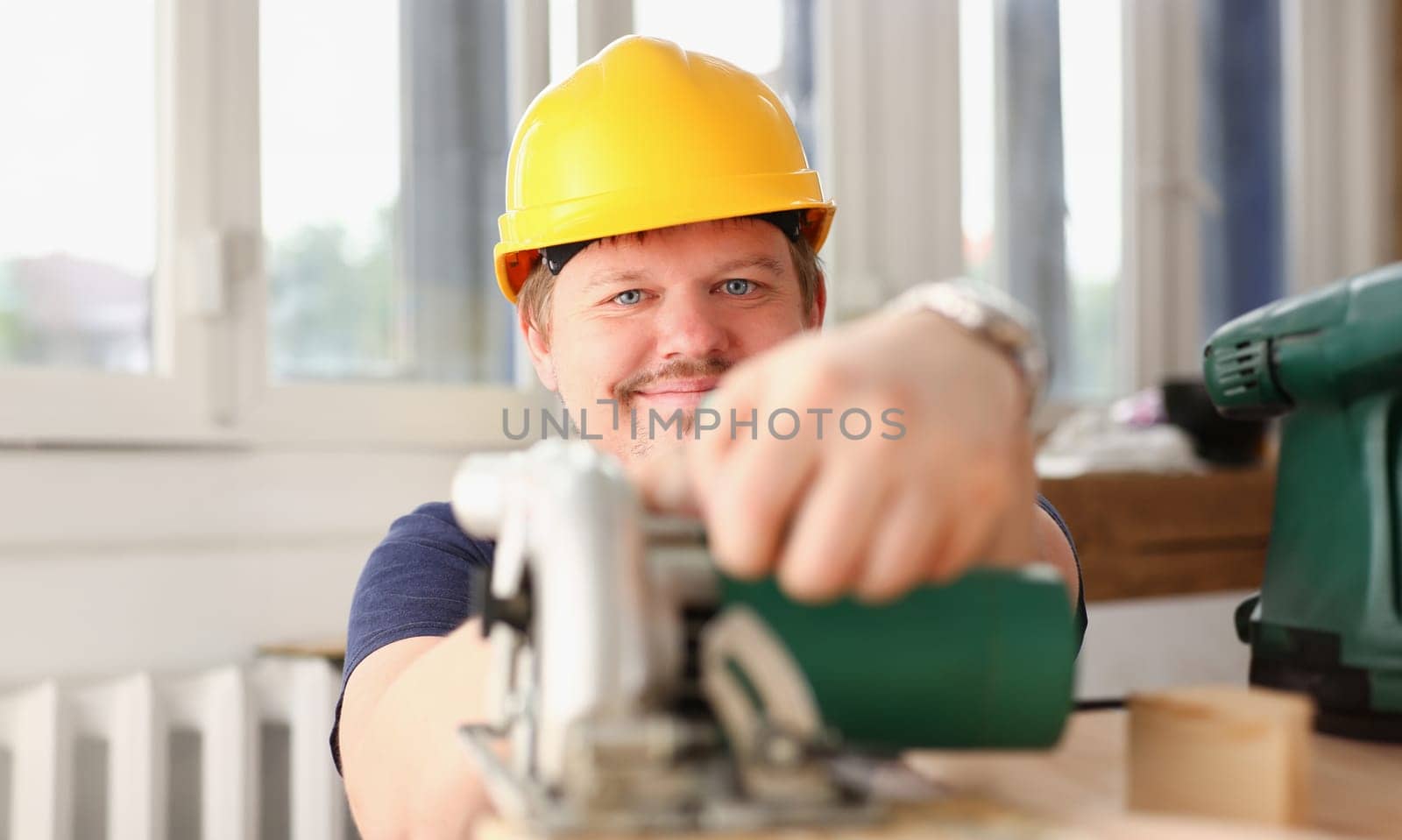 Worker using electric saw portrait. Manual job workplace DIY inspiration improvement fix shop yellow helmet hard hat joinery startup idea industrial education profession career concept
