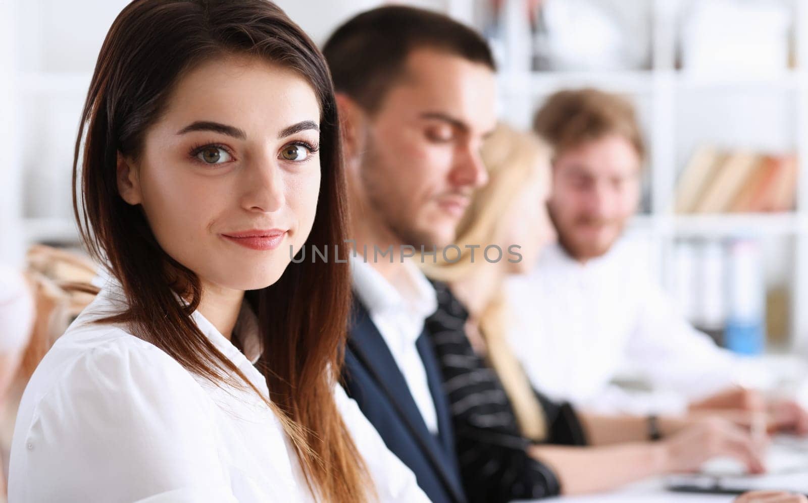Beautiful smiling woman portrait with group of people listen carefully during seminar. Study event client conversation job customer support service case hear in court leader performance concept