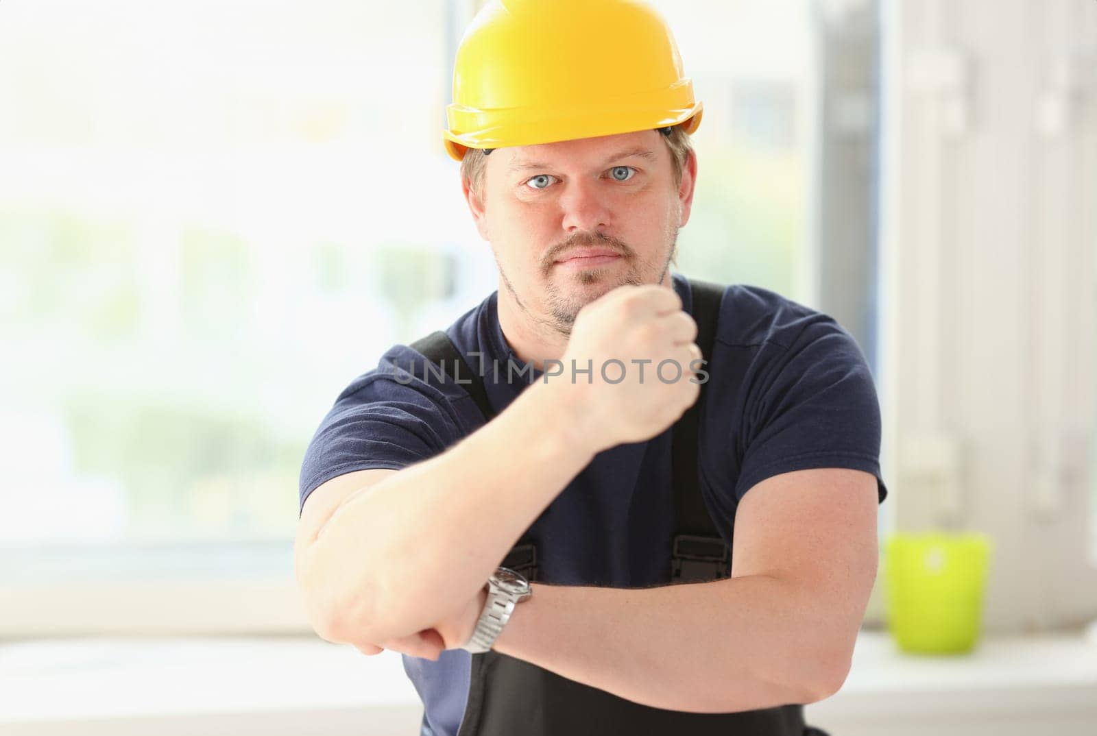 Smiling funny worker in yellow helmet posing. Manual job workplace DIY inspiration improvement fix shop hard hat joinery startup idea industrial education profession career concept