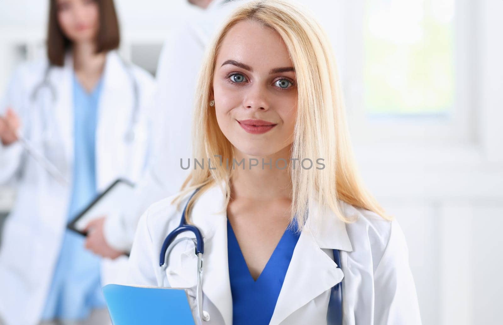 Beautiful smiling female doctor stand in office portrait. Physical and patient disease prevention exam er ward round 911 prescribe remedy healthy lifestyle consultant nurse profession concept
