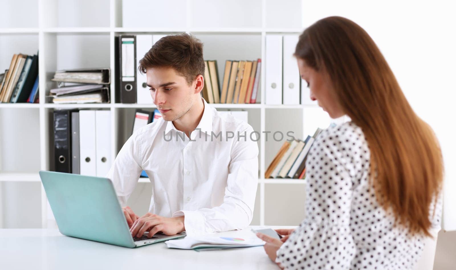 Group of people deliberate on problem with laptop pad closeup. White collar check money papers stock exchange market earnings list partnership agreement idea discussion startup concept