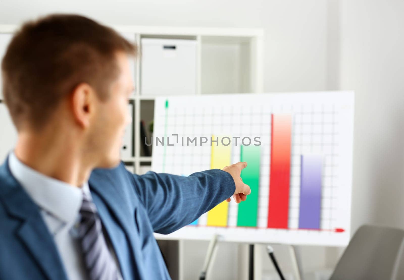 Man in suit point with arm in stats graph in office closeup. Stock exchange market advisor sale examination industry profit research occupation account career present ambition negotiation study trade