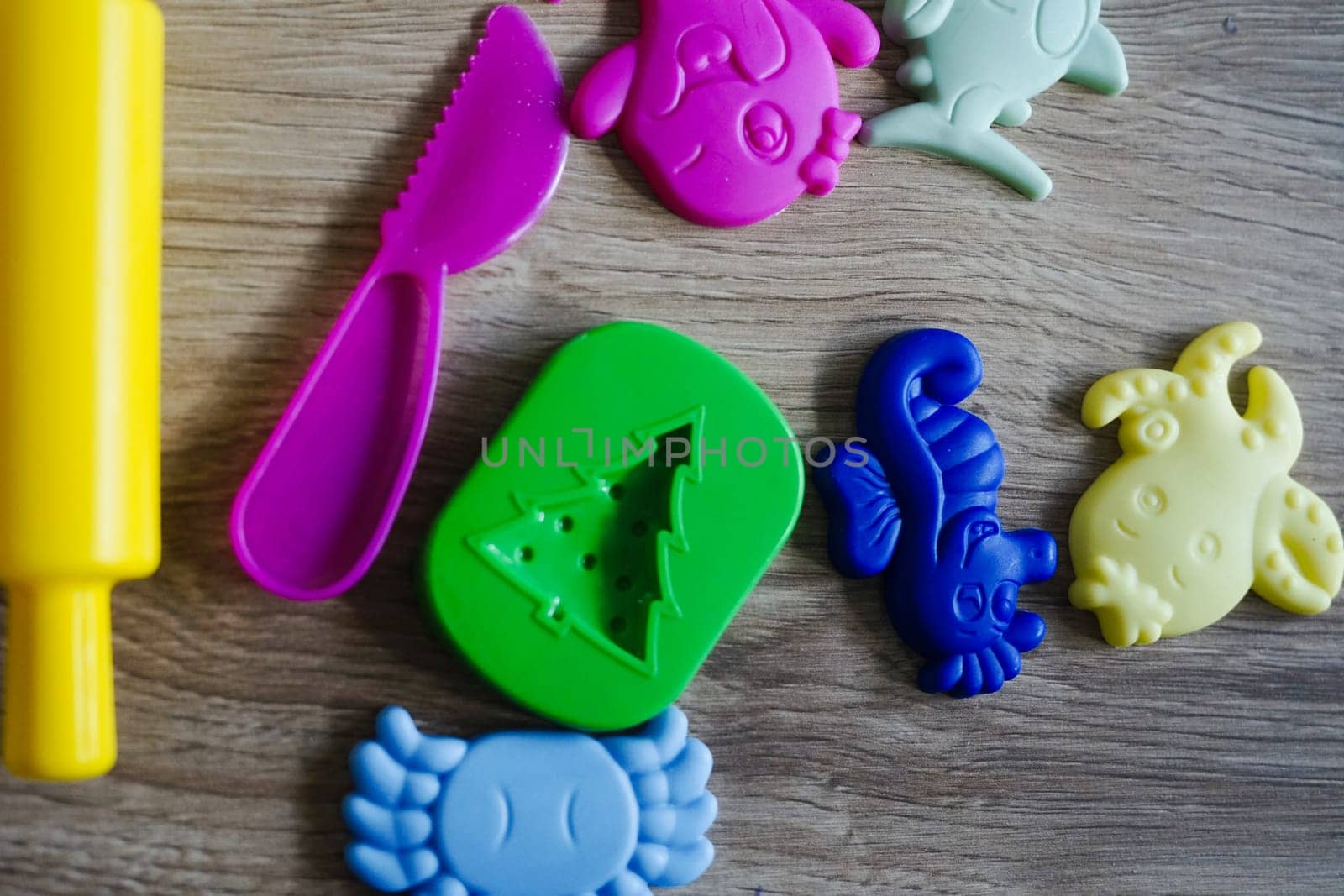 play dough colorful various shapes yellow roller pink knife sea animals themed wooden play game fun . High quality photo