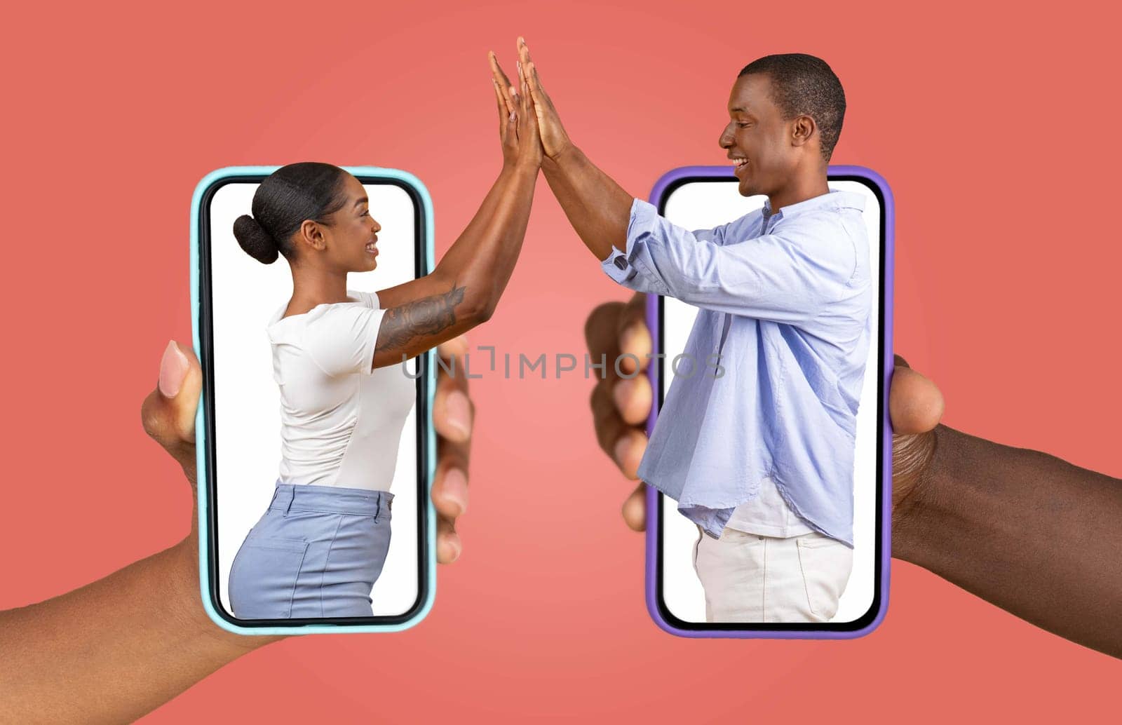 African American couple is connecting through their smartphones, showcasing their love and affection. They appear engaged in a joyful exchange, representing a modern relationship in the digital age.