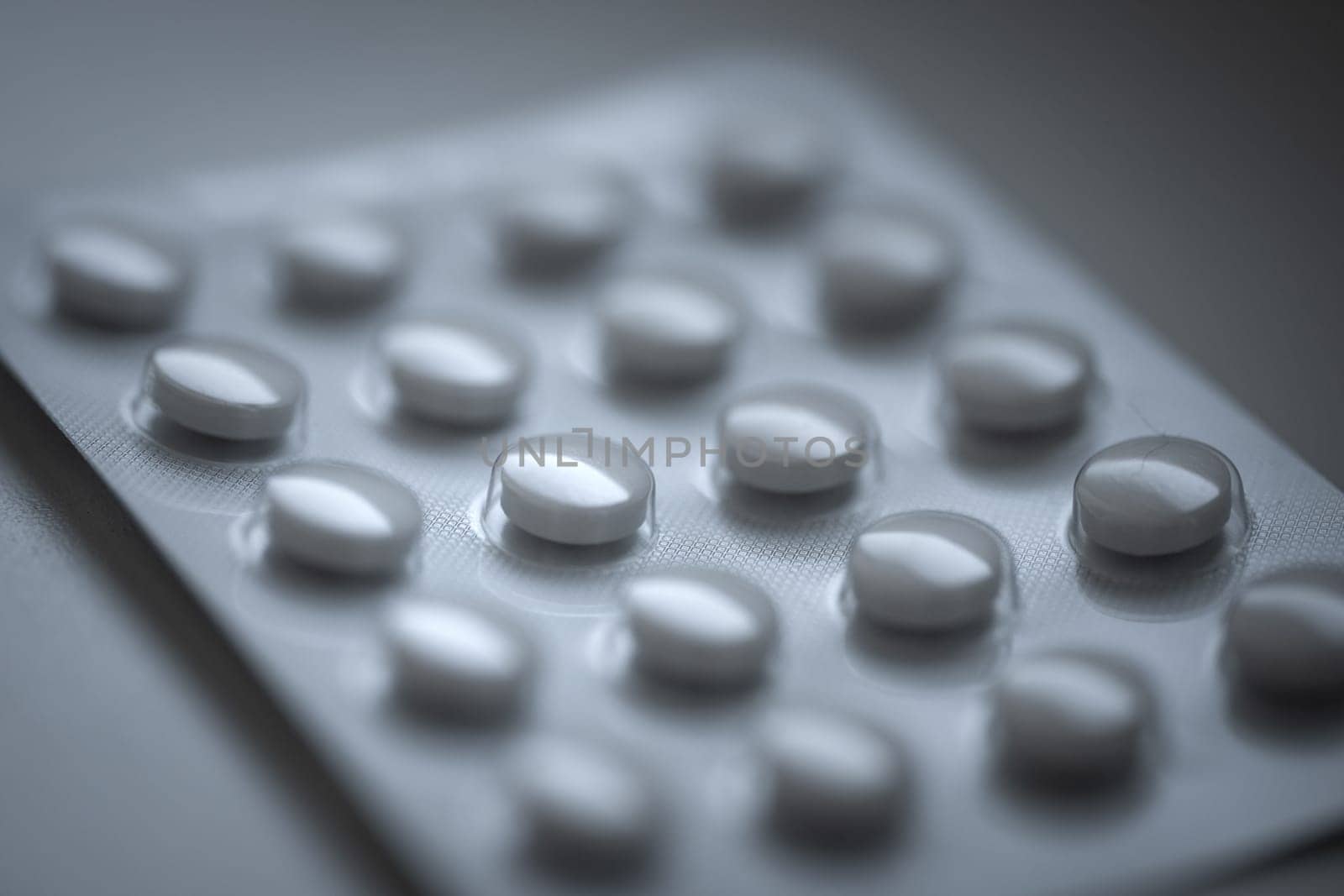 Closeup of pills in blister pack. Headache pills, painkillers, antibiotics or antidepressants tablets. High quality photo