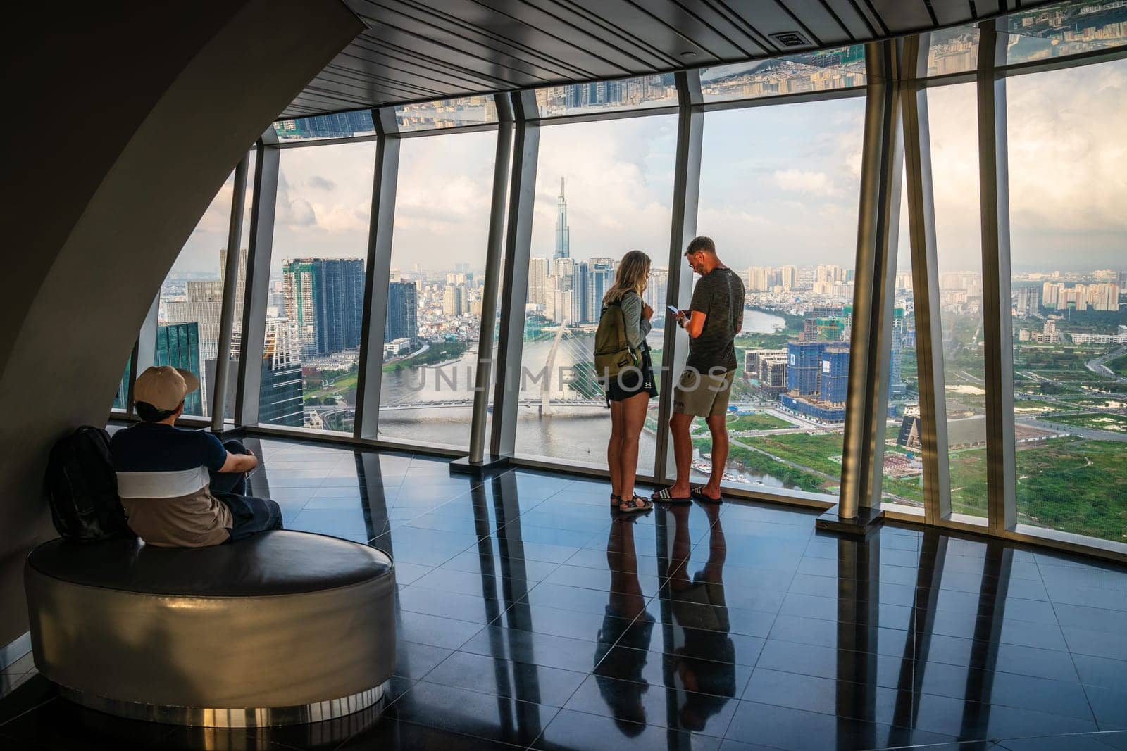 Ho Chi Minh City, Vietnam, November 24, 2022: Tourists are enjoying the aerial view of the city from the Saigon Sky Deck in Ho Chi Minh City, Vietnam