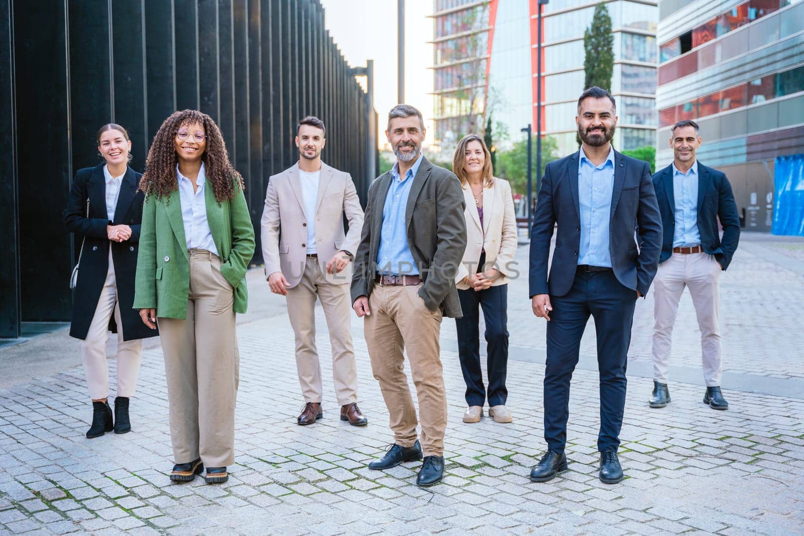 A diverse group of business professionals confidently standing outdoors . The image conveys professionalism, teamwork, confidence, and modern business attitudes, perfect for corporate themes.