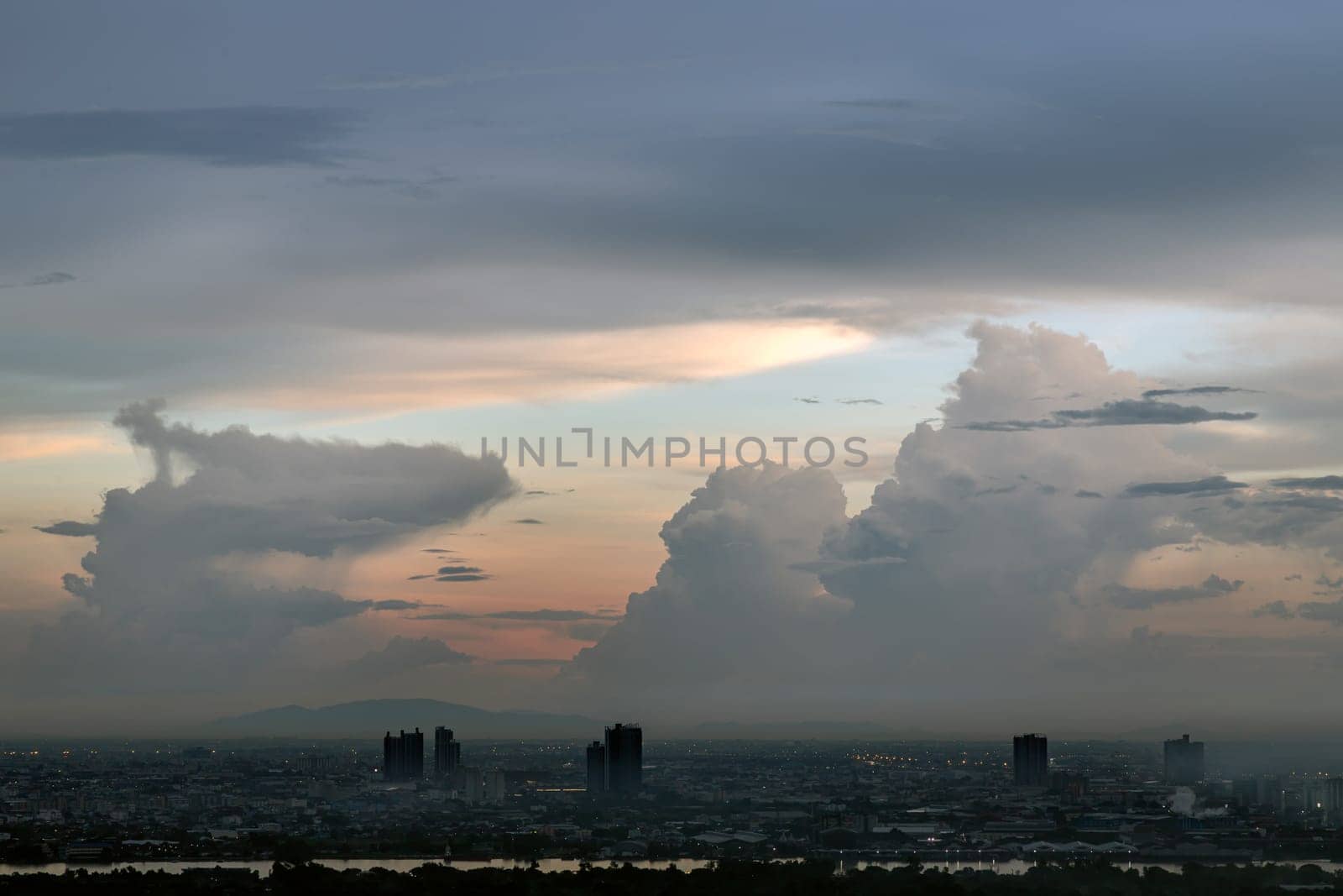 Bangkok, Thailand - 13 Oct, 2024 - Aerial view of Bangkok city and beautiful clouds in sky background with the Chao Phraya River before sunset. use it as your wallpaper, poster and Space for text, Selective focus.
