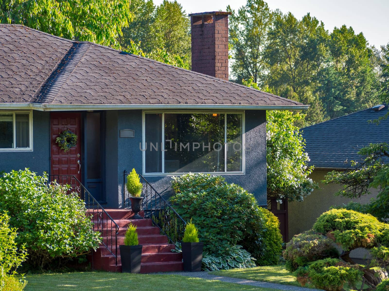 Main entrance of detached residential house on warm summer everning.