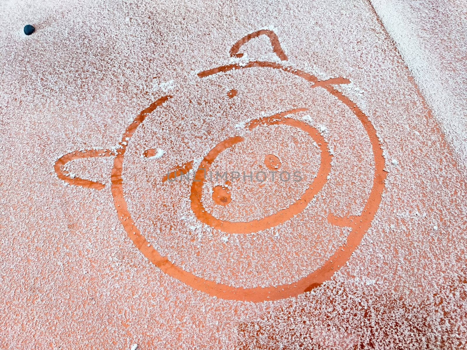 Snow on a playground features a playful pig design, showcasing creativity in a winter setting, perfect for children's imagination.