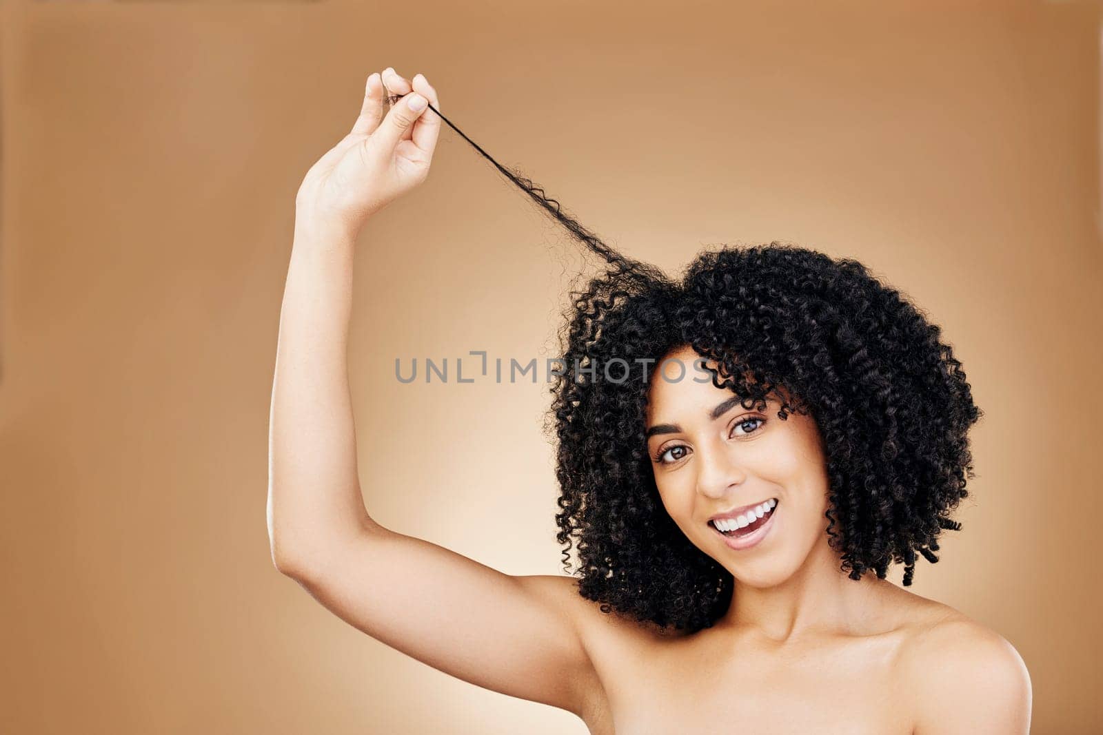 Woman, portrait and hair, curly with shine and beauty, smile for salon treatment and strong texture on studio background. Face, skin and glow with growth, haircare and cosmetology with model and afro.