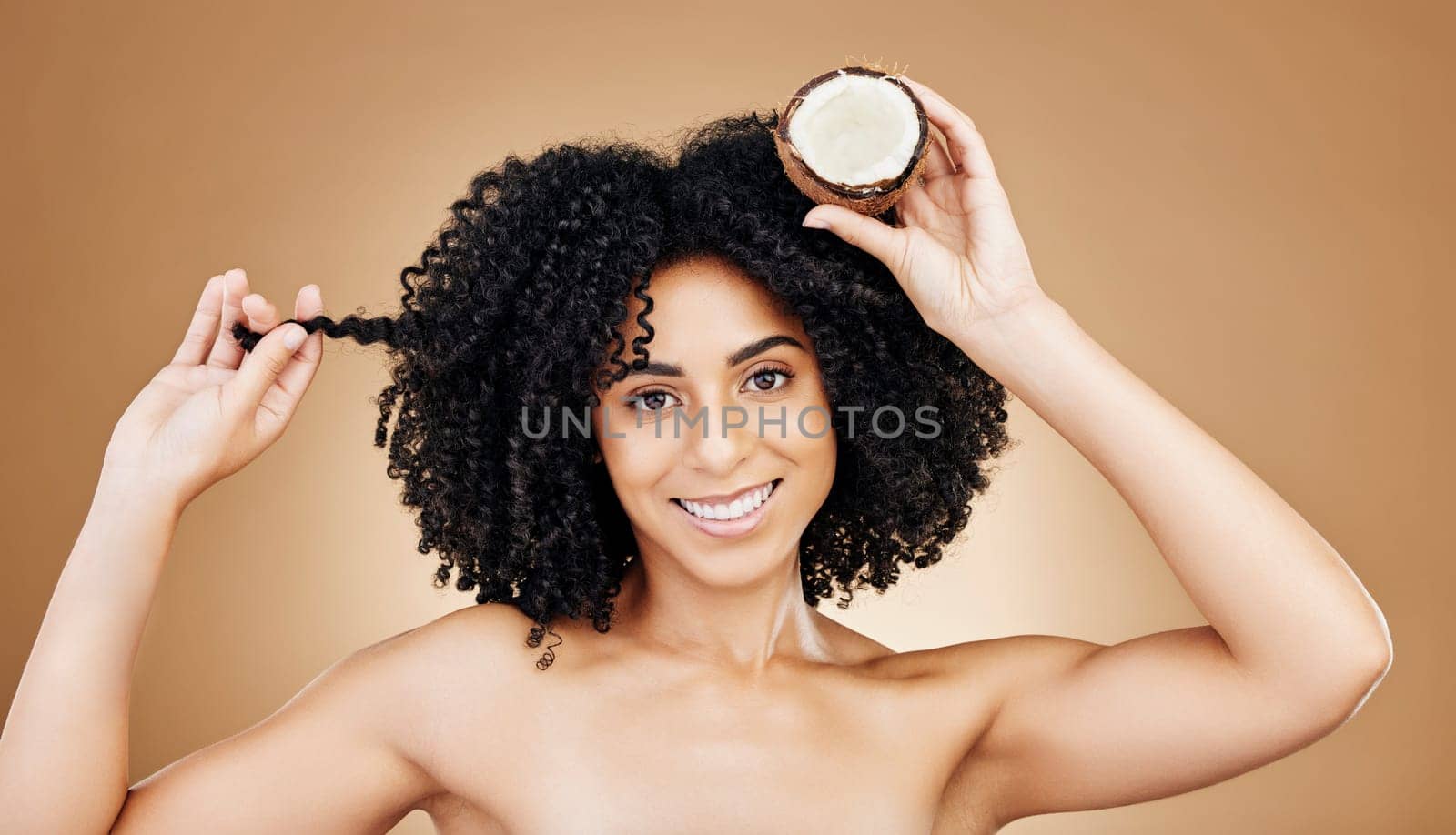 Woman, hair and coconut in portrait, beauty and product for wellness, oil or cream with cosmetics on studio background. Organic, eco friendly and haircare for growth and strong texture with fruit.